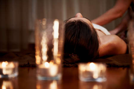 In the foreground candles, in the background the massage. Hardwood floors. state of relaxationの写真素材