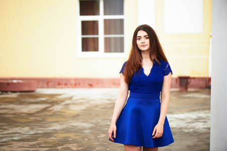 beautiful young woman in dress goes to meetの写真素材