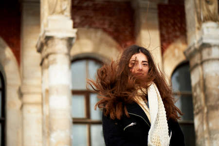 The wind in your hair. Young girl looking at the camera. Long dark and brown eyes .の写真素材