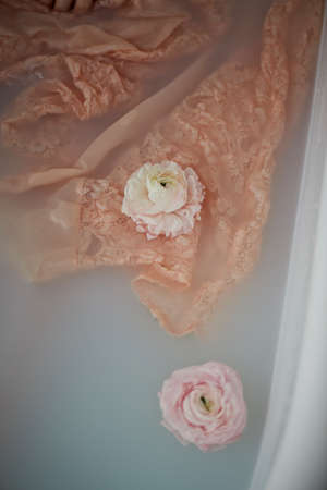 Wet creamy lace floats in water a milky color. A feeling of tenderness beautyの写真素材