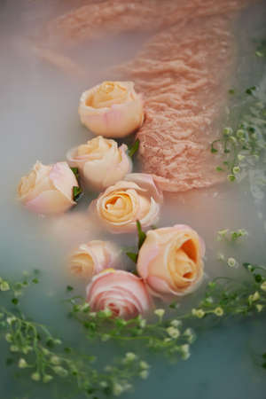 Wet creamy lace floats in water a milky color. A feeling of tenderness beautyの写真素材
