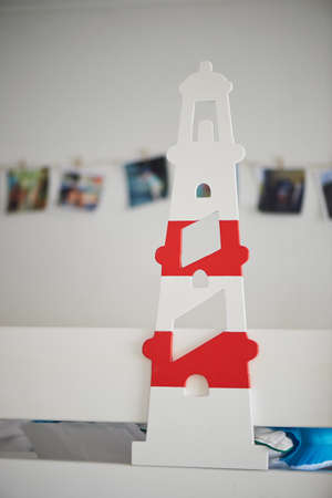 Lighthouse deviatiny wood, painted white with color accent decorating the nursery.の写真素材