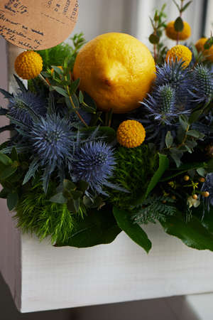 A spring bouquet in a white wooden box in the yellow-green spectrum. lemon.の写真素材