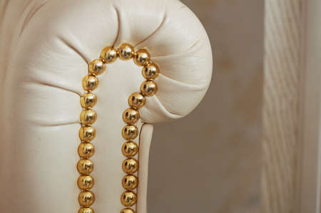 Armrest white leather armchair, upholstered in gold studs with heads.Retroの写真素材