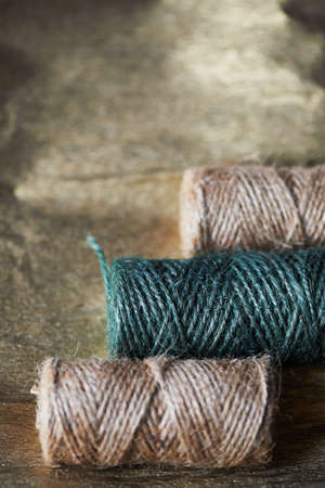 A ball of jute thick threads of brown and green. 3 skeinsの写真素材