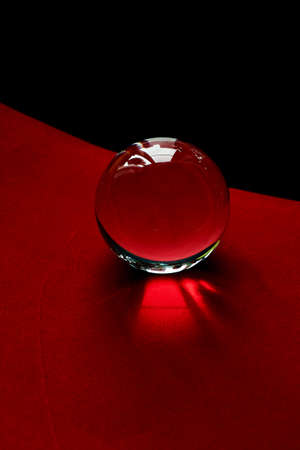 Glass globe or drop of water on a background of red and black velvet paper. Clean and Shineの写真素材