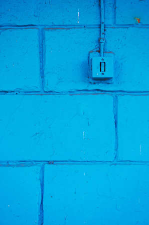 The old switch in the web on the blue brick wall. Vintageの写真素材