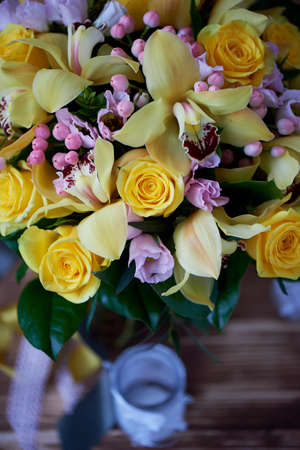 Fresh yellow bouquet of yellow roses and pink berries. Bright colorsの写真素材