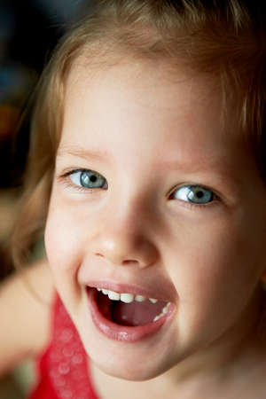 Baby with a tuft on the head,with blue eyes and playful smile