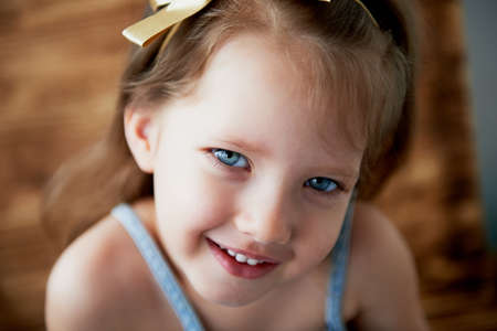 Baby with a tuft on the head,with blue eyes and playful smileの写真素材