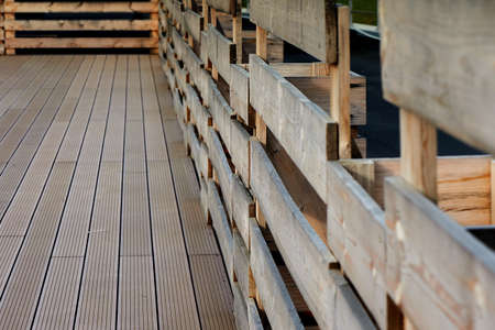 Decking and fence on a flat roof, against the sky,the forest and field