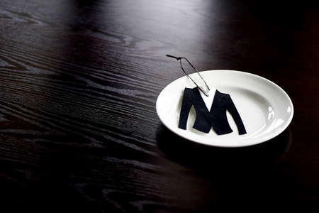 The little jacket is cut from velvet paper.On the plate, which stands on dark wooden background