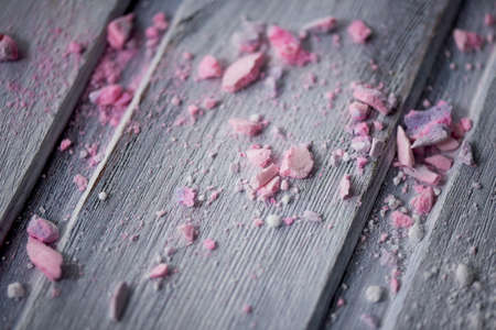 crumbs from pink cupcake on bright wooden surface
