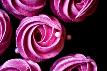Many purple marshmallow on a dark surface. A contrasting picture.A work of culinary artの写真素材