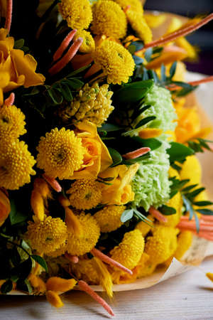 Yellow bouquet with green carnation,in the composition of chrysanthemums, roses and dyed grainsの写真素材