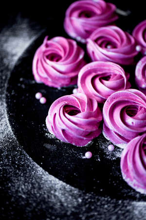 Many purple marshmallow on a dark surface. A contrasting picture.A work of culinary artの写真素材