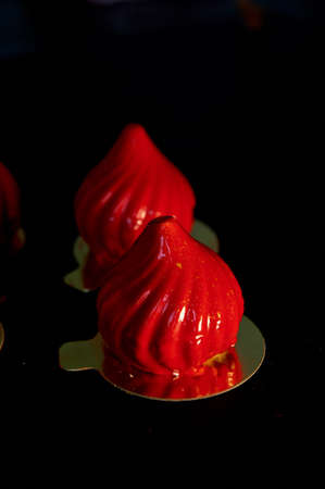 Fire berry cake, A delicate cream mousse, covered with incredibly shiny mirror-like glaze on the condensed milk, hides inside serdtsevinka of lemon jelly and ganache is incredibly useful oblepiha. Based cupcake crunchy almond-coconut decoys with hints of の写真素材