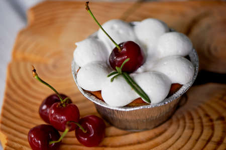 cheesecake with cherries in tartlets. On wooden frame interesting shapesの写真素材