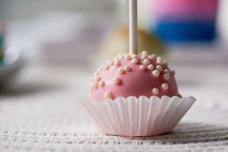 cake pop on a stick on a wooden background. Beautiful candy pastel shadesの写真素材