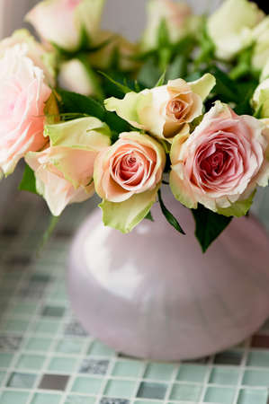 Bouquet of pink roses on the windowsill, in a pink vase. the atmosphere of cozinessの写真素材