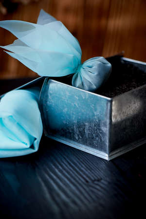 silk tea bag. Next tin with a large leaf black tea. The emergence of the tea traditionの写真素材