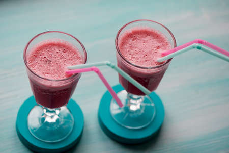 Fresh cool smoothie in a glass with a stem. Delicious and healthy Breakfast. Of cherries and strawberriesの写真素材