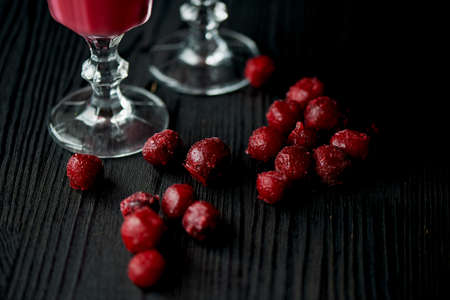 Fresh cool smoothie in a glass with a stem. Delicious and healthy Breakfast. Of cherries and strawberriesの写真素材