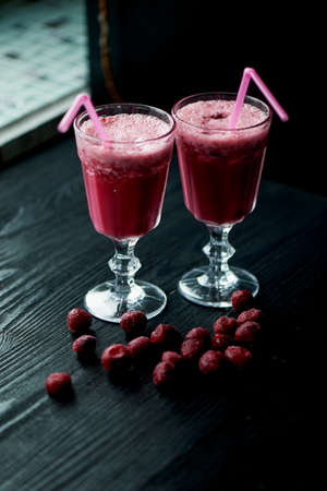 Fresh cool smoothie in a glass with a stem. Delicious and healthy Breakfast. Of cherries and strawberriesの写真素材