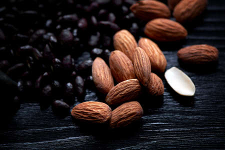 Almonds and sunflower seeds in chocolate on a dark background.Studio.