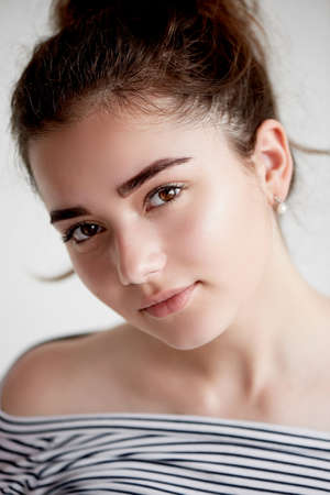 Portrait of young beautiful girl with brown eyes and black hair.Natural beauty, with clean glowing skin.の写真素材