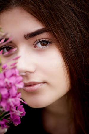 Beautiful bride in bright lace dress. In a field with Ivan-tea. Natural beauty, minimal makeup and loose hair. A child of natureの写真素材