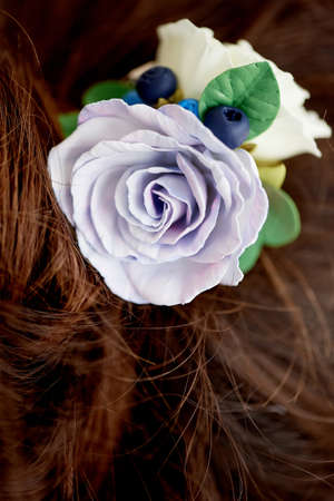 Hair in a bun. Hair accessory handmade. Close. Face not visibleの写真素材