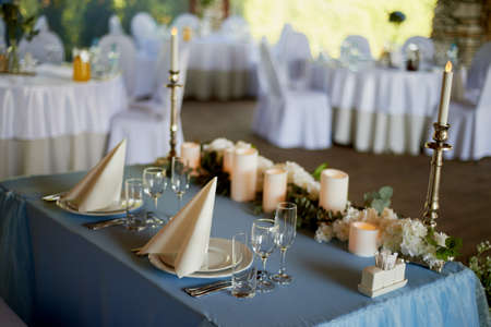 Stylish, fashionable wedding arch ceremony decorated with blue and white different flowers. Floral Design. Summer restaurant outdoors by preparation for wedding background on the river or sea.の写真素材