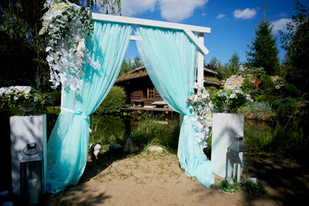 Wedding Arch of turquoise color on the background lakeの写真素材