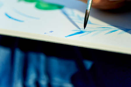 the creative process of watercolor painting. Thin brush touches the canvasの写真素材