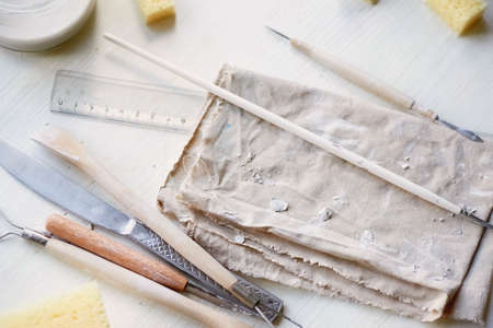 The workplace of ceramist. Blanks for painting. A creative workshop . Minimalistic composition in bright colorsの写真素材