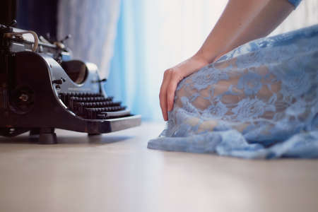 A creative person, author of books, writer of bestsellers, a journalist typing on an old typewriter. Inspiration in the workの写真素材