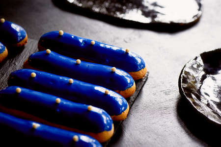 Blue eclairs with a mirrored glaze. A work of culinary art. Cakesの写真素材