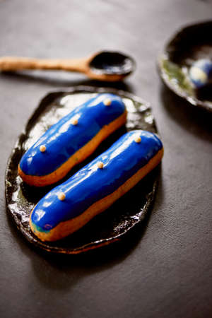 Blue eclairs with a mirrored glaze. A work of culinary art. Cakesの写真素材