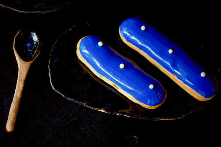 Blue eclairs with a mirrored glaze. A work of culinary art. Cakesの写真素材