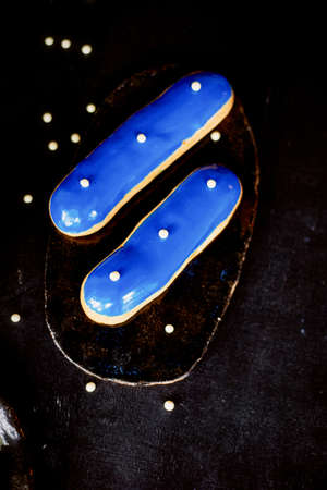 Blue eclairs with a mirrored glaze. A work of culinary art. Cakesの写真素材