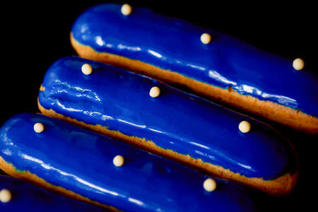 Blue eclairs with a mirrored glaze. A work of culinary art. Cakesの写真素材