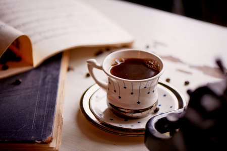 cozy coffee Cup next to the book. Retro photography in warm tones ofの写真素材