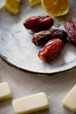 Fun atmosphere of a cozy evening eating dates, oranges, dominoes and dreams about travelの写真素材