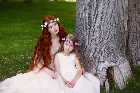 The red-haired girl with the baby, daughter or sister. Delicate and long-haired.