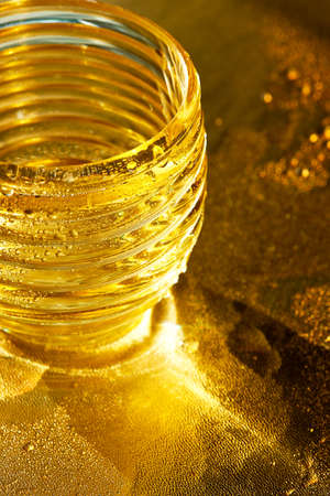 Golden texture with water drops. Thirst and its quenching