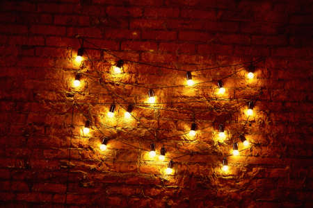 Edison light bulb hanging on a long wire. Cozy warm yellow light. Retroの写真素材