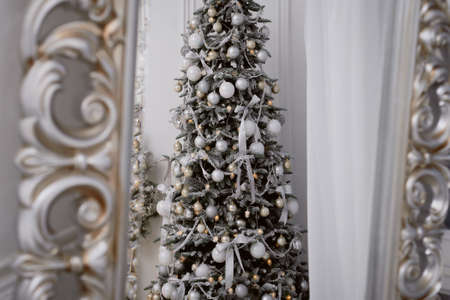 Christmas tree decorated with white balls and frostの写真素材