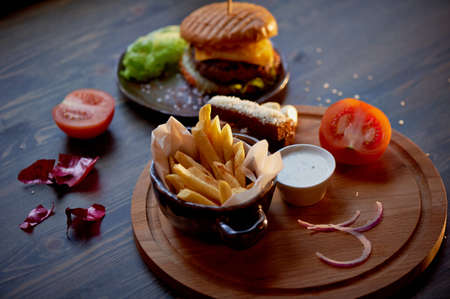 Wood top on her fries and Burger. The concept of the pub and fast foodの写真素材