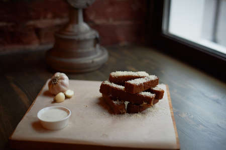 Garlic croutons on a on oiled paper. Photos atmospheric, rough, rustic style.の写真素材